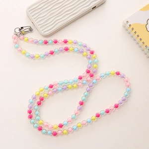 Detail of colorful acrylic beaded phone strap with glossy interior coloring and metal clasps