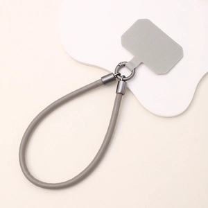 Detailed view of grey leather phone wrist strap with gunmetal clasps and insert card