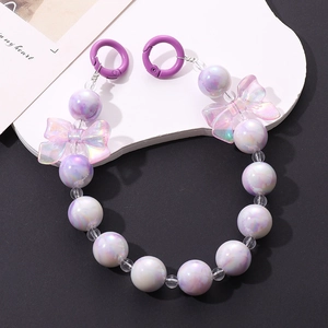 Detail of beaded phone strap with purple marble beads and translucent butterfly bows