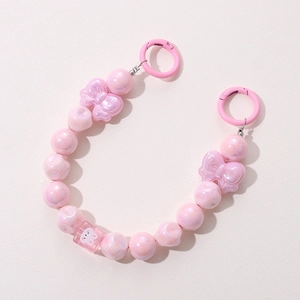 Close-up of pink iridescent beaded strap featuring a cute bunny bead and bow charms