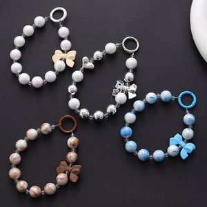 Selection of beaded phone charms with bows in white, silver, blue, and brown resin
