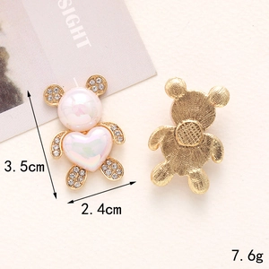 Pink pearl bear charm with gold metal frame and rhinestones showing front and back view