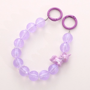 Detail of purple glitter beads and unicorn charm on a versatile multi-purpose phone strap
