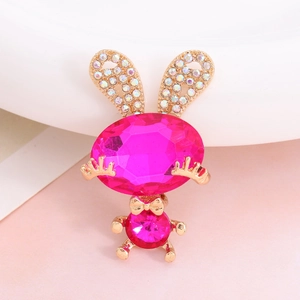 Detailed macro shot of a golden bunny charm with pink gemstone and sparkling crystals