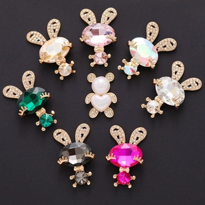 Macro shot of colorful crystal rabbit charms and a heart pearl bear for DIY accessories
