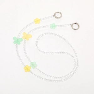 Beaded crossbody phone strap with acrylic flowers and butterflies on a white background