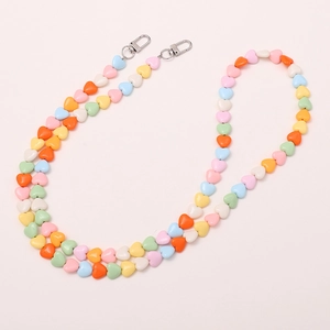 Gros plan de perles en cœur macaron avec fermoirs mousquetons argentés pour téléphone