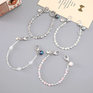 Close-up of five colorful acrylic and metallic beaded phone straps with lobster clasps