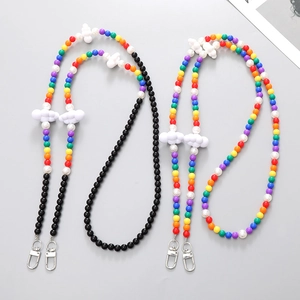 Rainbow beaded phone strap set with acrylic clouds and silver lobster clasps on gray background