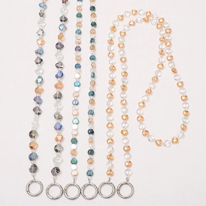 Detail of beaded mobile straps with crystal hearts and silver metal spring rings