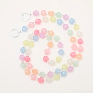 Detail of colorful macaron beaded strap with iridescent finish and white spring buckles