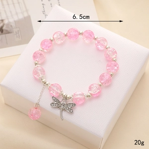 Pink beaded bracelet with a silver dragonfly pendant and sparkling wing accents