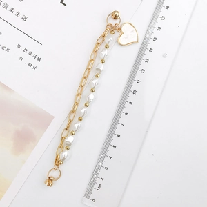 Gold chain and irregular pearl charm bracelet with heart pendant, length approx 17cm