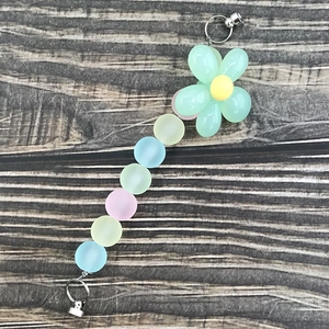 Detail of macaron matte beaded chain with a green flower charm and metal clasps
