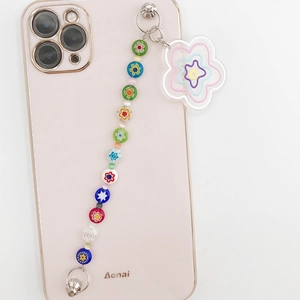 Close-up of colorful beaded phone charm with a large layered acrylic flower pendant