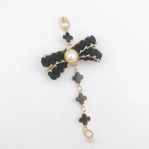 French vintage style bow bracelet with pearl accent and black clover charms