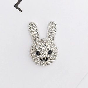 Close-up of a silver bunny pendant with sparkling rhinestones for DIY jewelry crafts