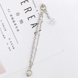 Detail of silver double chain bracelet with colorful iridescent butterfly pendants and charms