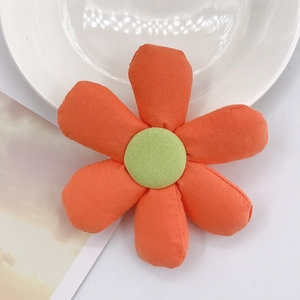 DIY fabric sunflower accessory in bright orange and green for phone cases and hair clips