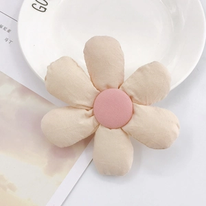 Close-up of a pink padded fabric sunflower accessory for hair clips and DIY crafts