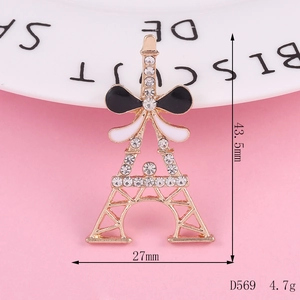 Golden Eiffel Tower charm with black enamel bow and sparkling crystal rhinestones