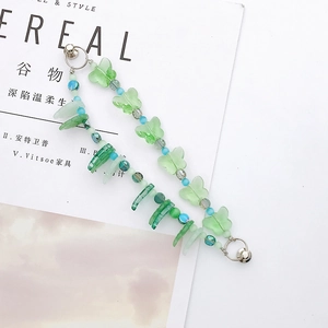Close-up of green butterfly beaded chain with silver spring clasps on white background