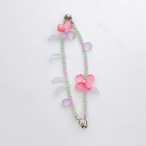 Detail of pink and green beaded chain with floral resin charms and silver lobster clasps