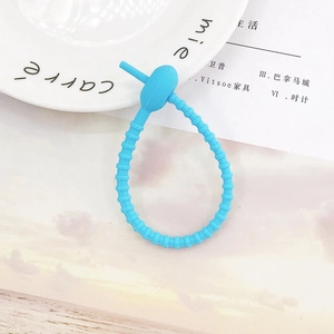 Close-up of a blue silicone cable tie with non-slip texture for DIY accessory storage