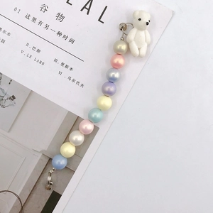 Detail of colorful gradient acrylic beads with a white flocked bear charm for phone cases