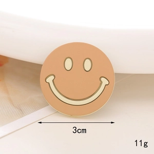 Detailed view of 3cm round latte brown pearl smiley face DIY accessory with diamond inlay