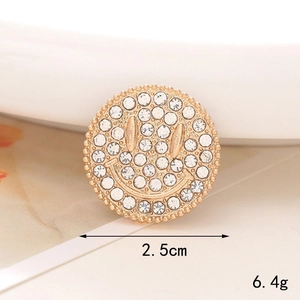 Detailed view of 2.5cm gold alloy smiley face charm with rhinestones and pearl accents