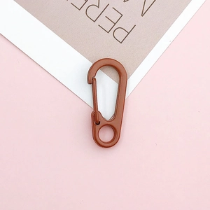 Close-up of a reddish-brown spring lobster clasp with a matte finish for DIY keychains