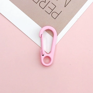 Macro view of pink candy-colored lobster clasp with D-ring and spring gate mechanism