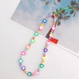 Detailed macro view of colorful Y2K beaded phone strap with macaron beads and resin bear charm