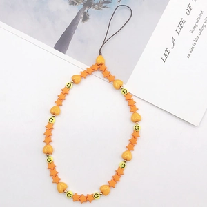 Detail of handmade bright orange beaded phone strap with star and heart shapes