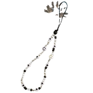Handmade smile face and heart bead phone charm strap in black, white, and gold design