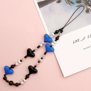 Close-up of DIY acrylic heart beads mobile strap with blue heart charms and pearls