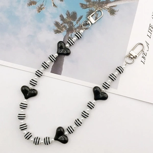 Detail of acrylic heart bead lanyard with black-white stripes and silver lobster claws