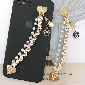 Golden chain phone strap with white leather, pearl charms and camellia flower heart clasp