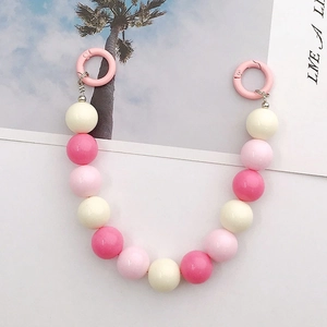 Detailed view of 16mm pink acrylic bead strap with round spring clips for handbags