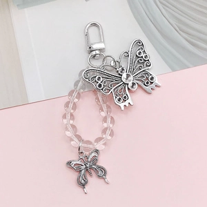 Detail of alloy hollow butterfly pendant with clear crystal beads and a silver clasp