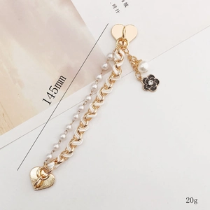 Gold-tone dual chain strap with heart clasp, pearls, and black camellia pendant, 145mm length