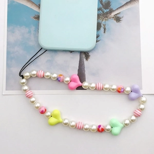 Colorful beaded phone strap with acrylic hearts and faux pearls on a blue case