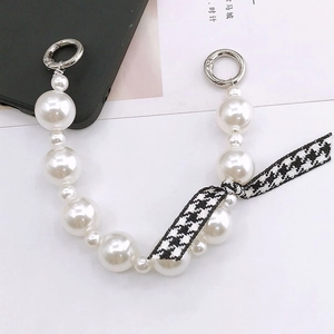 Detail showing pearl phone strap with houndstooth bow and silver metal spring rings