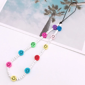 Detail of colorful smiley face beaded phone lanyard with polymer clay and seed beads