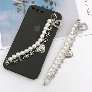 Dual-strand pearl and silver heart phone charm strap with sparkling rhinestone pendants