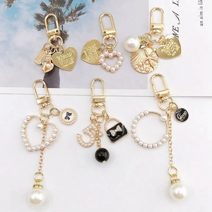 Golden zinc alloy keychain pendants with faux pearls and heart charms for DIY jewelry