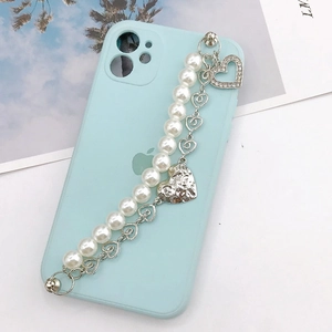 Light blue phone case featuring a pearl heart charm chain strap with silver accents