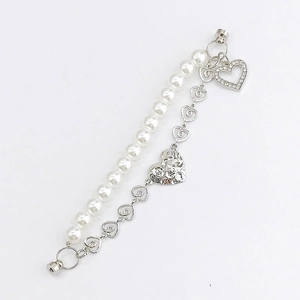 Close-up of double-layer heart pearl bracelet with silver heart charms and magnetic clasp