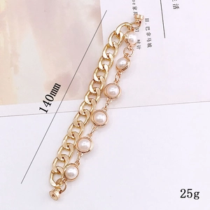 Double-layered golden Cuban link bracelet with white faux pearls and magnetic clasp